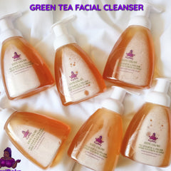 Green tea facial cleanser bottles with white pump, orange liquid, and KaziRokz label