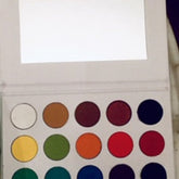 Eyeshadow palette with multiple colors, white case, and mirror inside