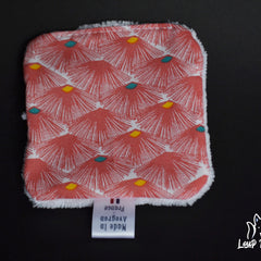 Printed fabric square with red floral pattern, white trim, and Made in France label