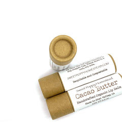 Lip balm tubes in brown cardboard with white labels, Sweet Poppy Homestead brand