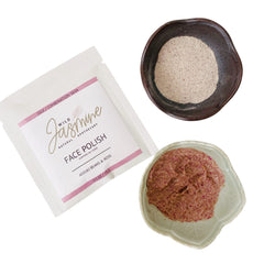 Face polish with white packet, pink accents, and Wild Jasmine branding, plus brown and pink product in bowls