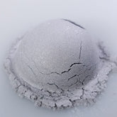 Close-up of Ghost Eye Shadow palette showing matte and shimmer shades in cool-toned neutrals with sleek black packaging