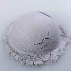 Close-up of Ghost Eye Shadow palette showing matte and shimmer shades in cool-toned neutrals with sleek black packaging