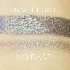 Close-up of Tundra Eye Shadow pan showing frosty silver-blue powder with shimmer particles