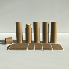 Lip balm tubes, brown cardboard material, with labels and exposed balm, natural style