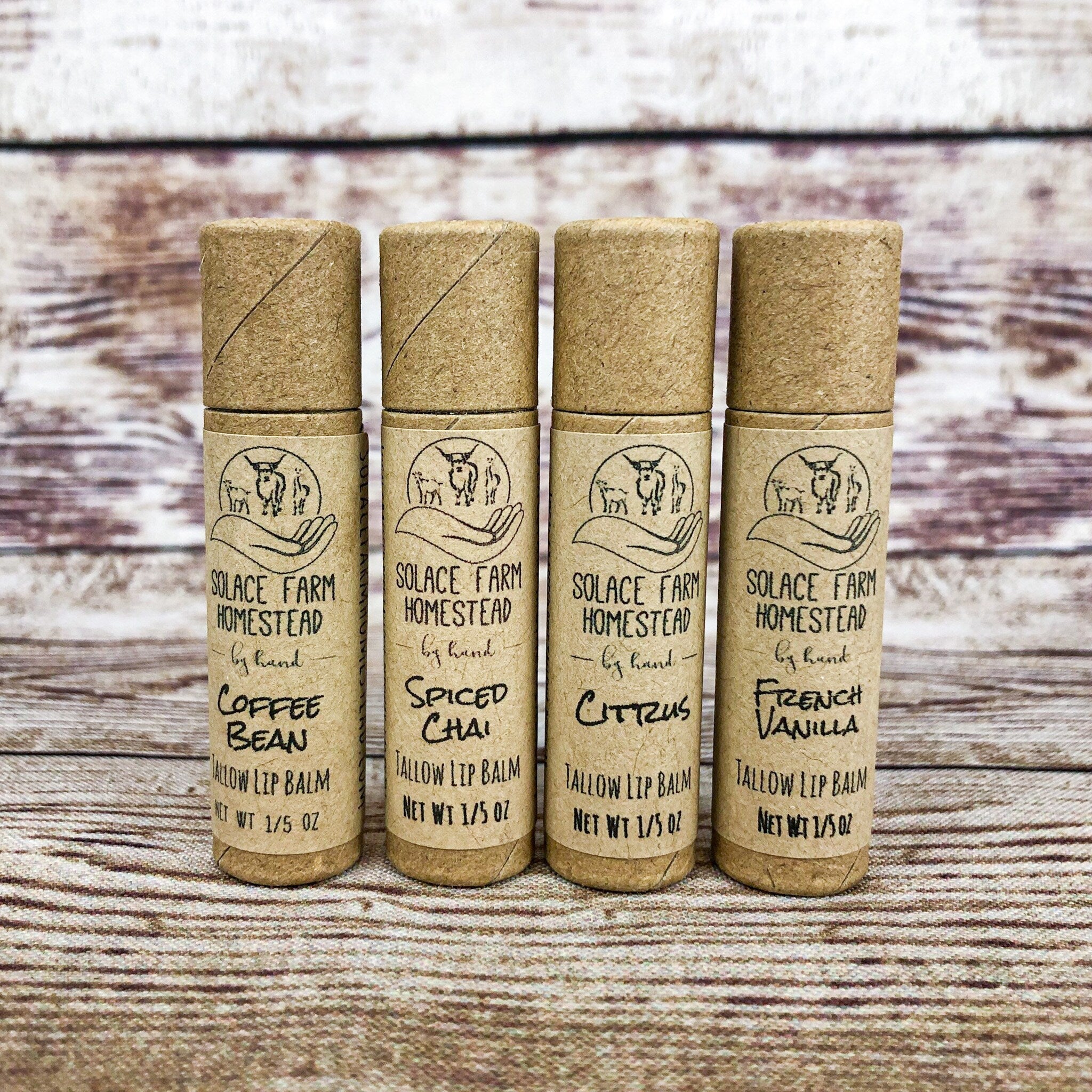 Lip balms in four brown paper tubes with Solace Farm Homestead brand text on them