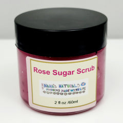 Rose sugar scrub jar, pink scrub, black lid, label reads Nanas Naturals, 2 fl oz size