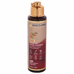 Facial cleanser bottle with gold cap and Roots & Herbs label, brown and maroon colors