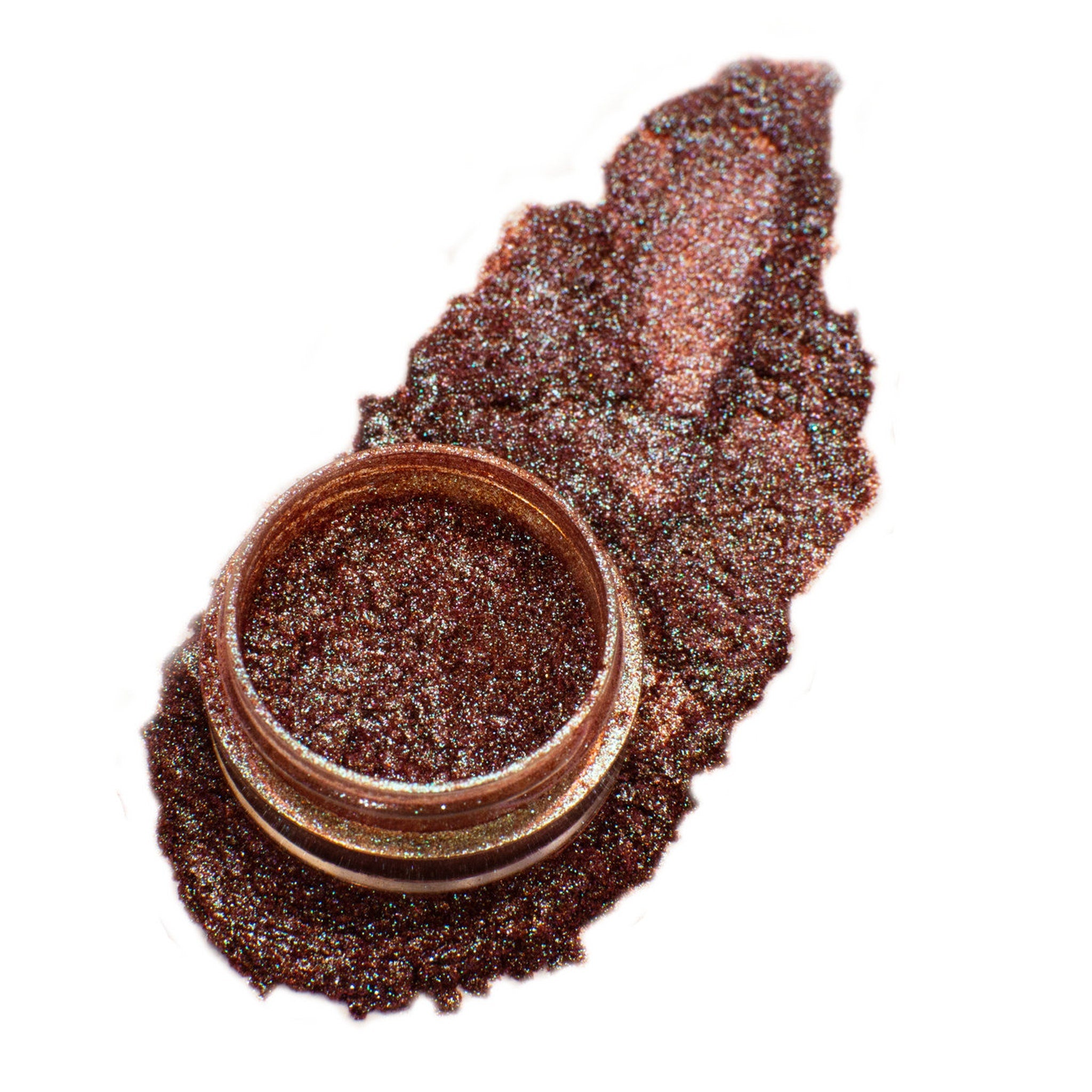 Glass jar of loose glitter eyeshadow pigment in vibrant 90s-inspired colors with shimmer particles