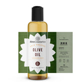 Amber glass bottle of cold-pressed olive oil with gold cap and minimalist label, showcasing premium skincare oil