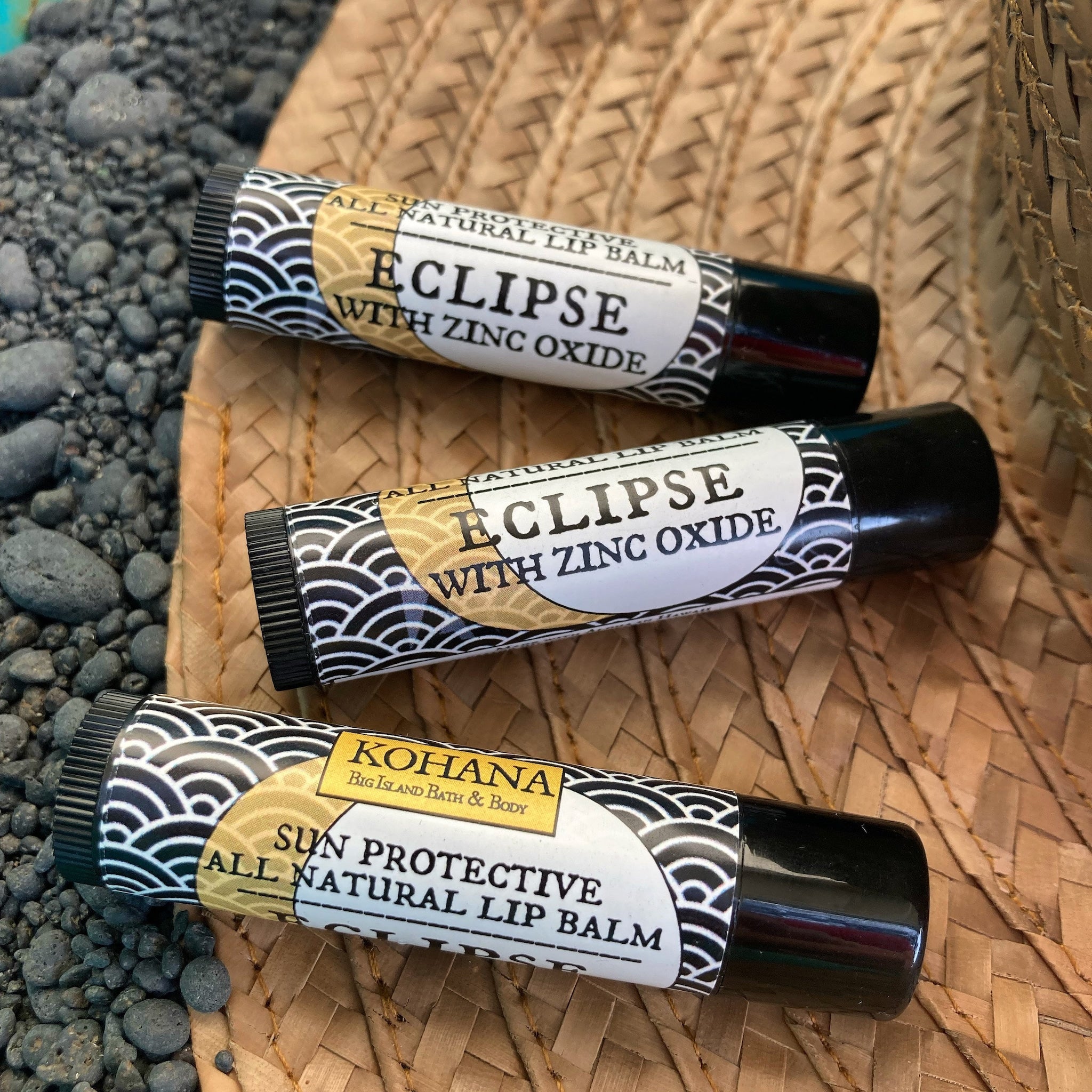 Lip balms with black tubes and wave pattern, Eclipse brand visible on label