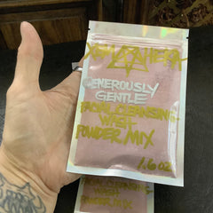 Facial cleansing powder mix in pink, XemHeka brand, held in a clear pouch