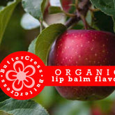 Lip balm flavor oil, red apple with green leaves, ButterCress logo on red circle, organic text