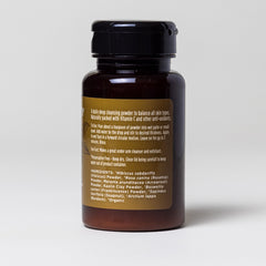 Cleansing powder bottle, brown glass, black cap, with label for use instructions