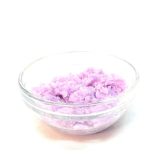 Lavender bath salts in clear glass bowl with white background