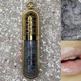 Glitter lipgloss with silver glitter, gold metallic casing, and lip application shown