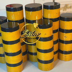 Close-up of golden turmeric honey scrub in jar with textured surface and natural ingredients visible