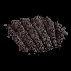 Powdered substance with dark brown color and textured appearance on black background