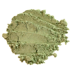 Close-up of matte sage green loose mineral eyeshadow with olive undertones in a vegan formula