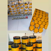 Golden turmeric and honey sugar scrub in a white jar with black label, showcasing natural skincare texture