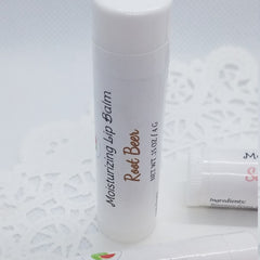 Lip balm tube with white label, "Root Beer" text, and Mellen Patch Soaps branding