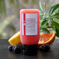 Translucent pink gel mask in a sleek white tube with gold accents, showcasing fruity extract formula