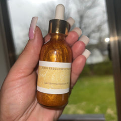 Golden shimmering body oil being poured onto hand, showcasing luminous texture and luxurious application