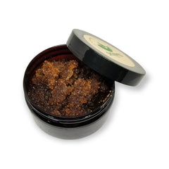 Brown sugar scrub in black jar with open lid, Skinvig branding visible