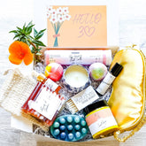 30th Birthday Gift Box with white box, orange flower, and Nizzy Naturals products