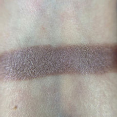 Close-up of Strange Eye Shadow Palette showing six vibrant matte and shimmer shades in circular pans
