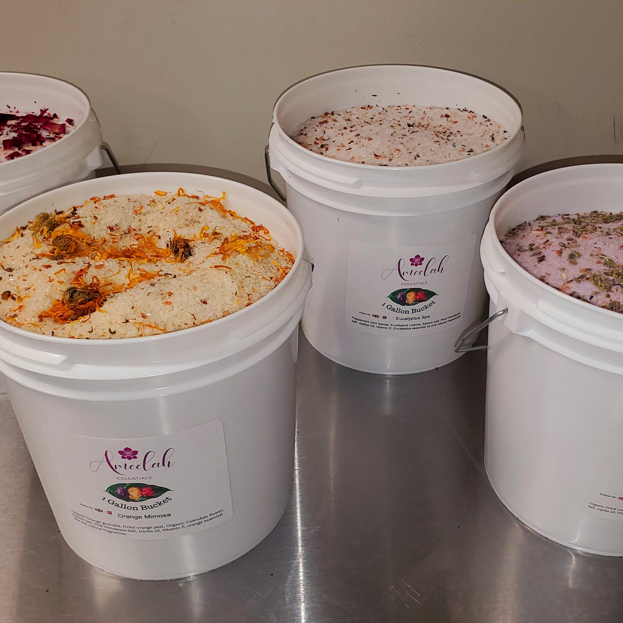 Bath salt buckets with white buckets, floral and herbal ingredients, Ameelah Essentials label visible