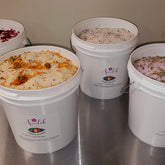 Bath salt buckets with white buckets, floral and herbal ingredients, Ameelah Essentials label visible