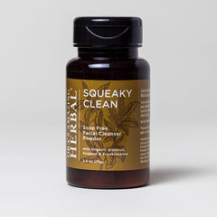 Facial cleanser powder in brown glass bottle with black cap, gold label, and herbal design