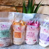 Bath salts in clear plastic bags, various colors, with ameelahessentials branding