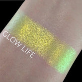 Eyeshadow swatch with yellow-green chromadescent shimmer on skin, Glow Life text visible