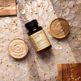 Facial cleanser powder with wooden bowls, licorice root pieces, and Ora's Amazing Herbal brand