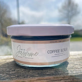 Coffee scrub jar with white lid, glass jar, and Wild Jasmine label