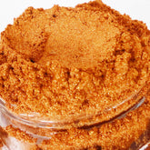 Eyeshadow product, copper shimmer powder, in a petite clear jar