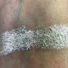 Close-up of Iapetus Eye Shadow Palette showing shimmering bronze and taupe shades with smooth, blendable texture