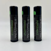 Lip balm tubes, black with green accents, Levs Naturals Peppermint text visible