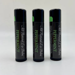 Lip balm tubes, black with green accents, Levs Naturals Peppermint text visible
