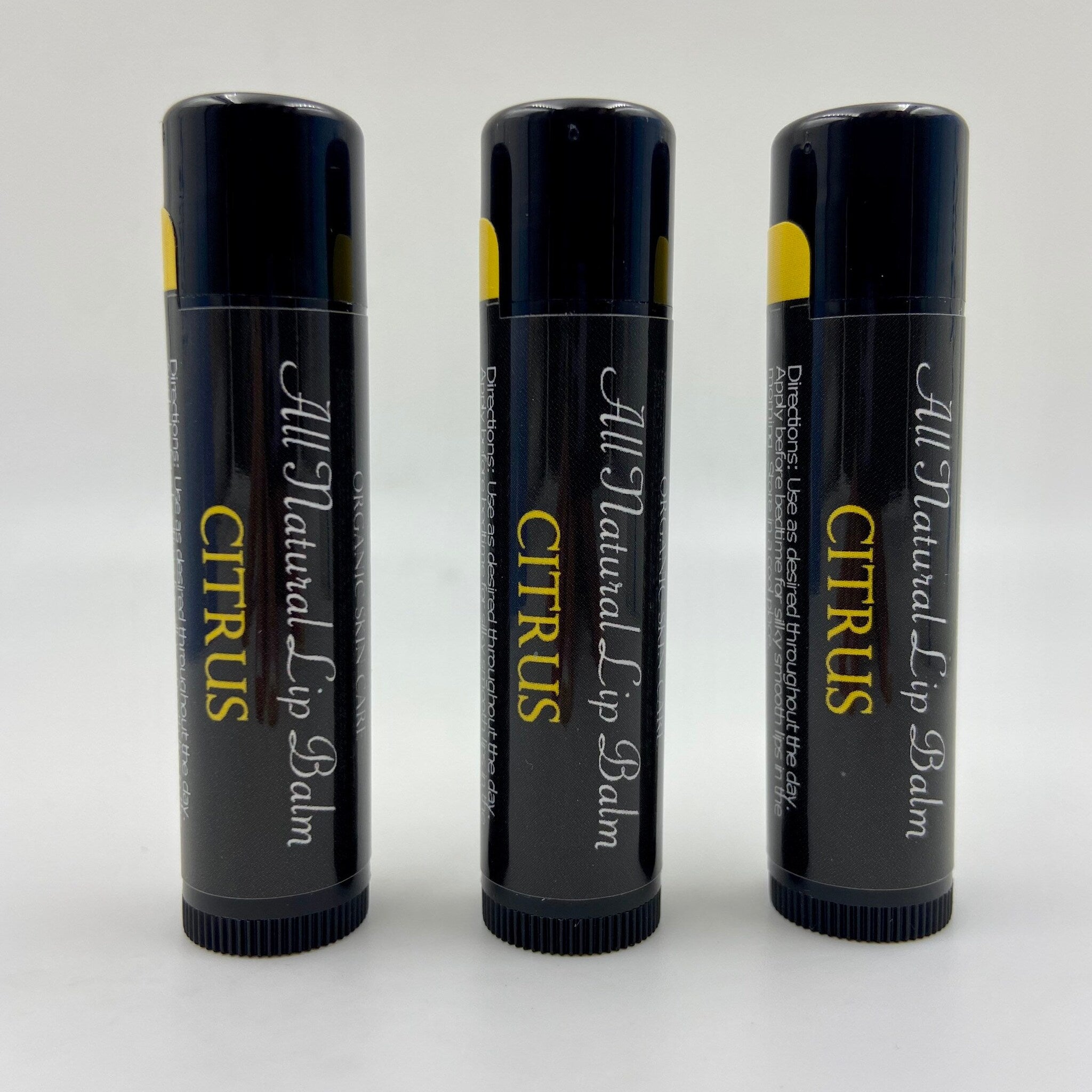 Lip balm tubes with black, yellow, and white text, Citrus flavor, Levs Naturals brand