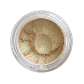 Loose gold mineral eyeshadow in a small black jar with gold lid, showcasing shimmering vegan powder texture
