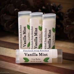 Lip balm tubes with white labels, green leaf design, and "Vanilla Mint" text, by Pineland Soap Kitchen