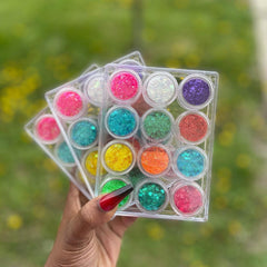 Hand applying iridescent glitter eyeshadow with fingertip, showcasing shimmering multicolor pigments on skin