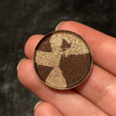 Single pressed eyeshadow in a sleek black compact with a mirrored lid, showcasing a metallic mercury silver shade.