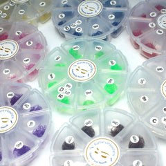 Eyelash extensions in various colors, lengths, and styles, Kimeyelashes brand in clear plastic containers