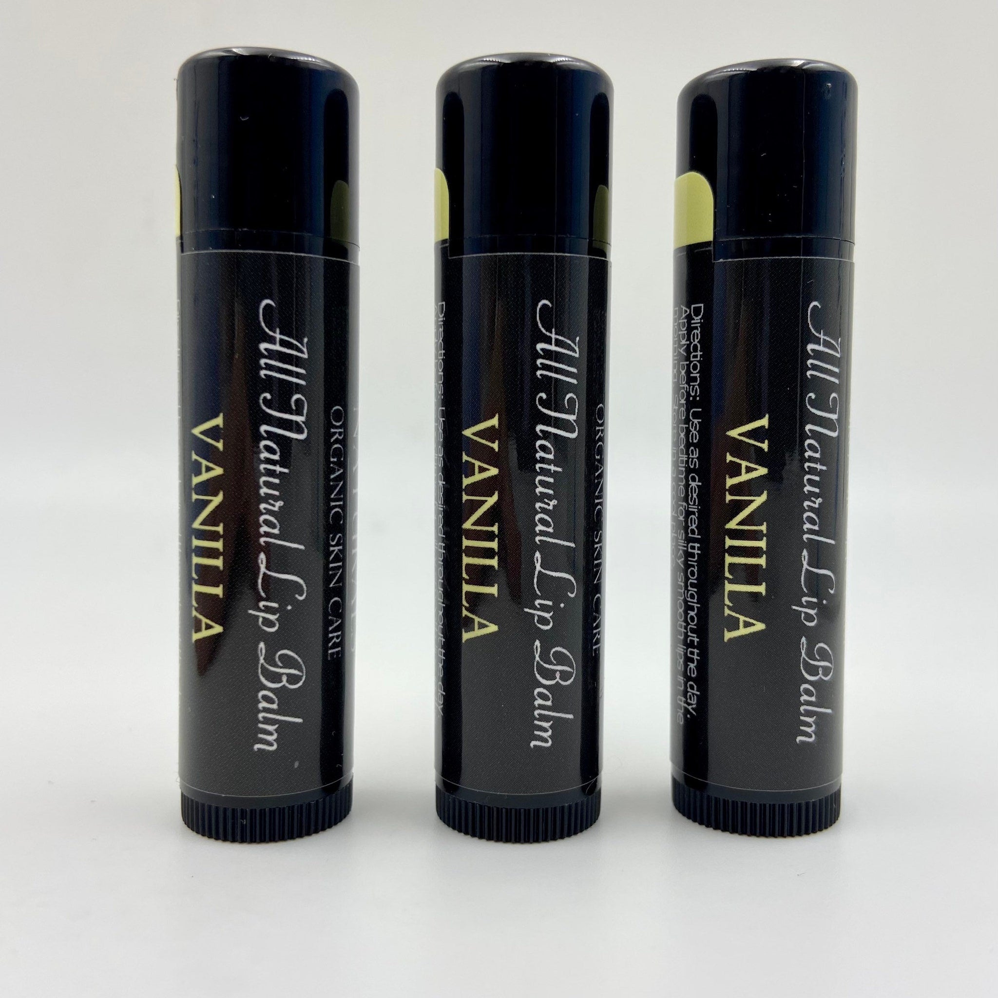 Lip balm tubes in black with white text, yellow accent, and "Vanilla" label