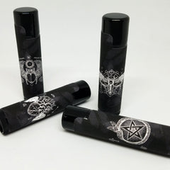 Black lip balm tubes with white graphic designs and black caps, various patterns