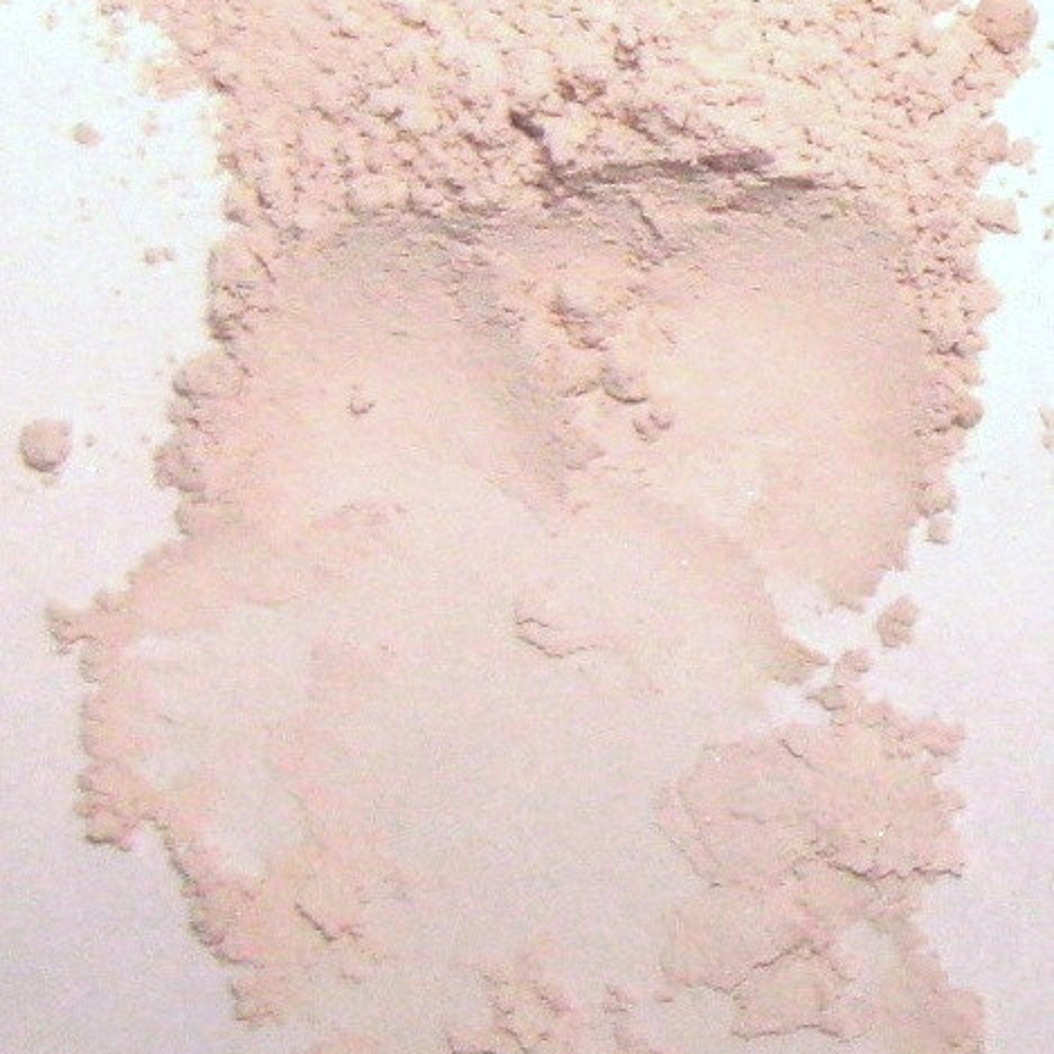 Close-up of soft matte pink vegan eyeshadow in compact with quartz-infused mineral makeup and silky texture